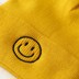Bild von gelbe Strickmütze mit aufgesticktem Smiley Gesicht