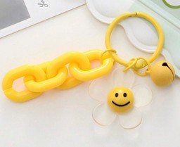 Bild von gelber Acryl Schlüsselanhänger mit Smiley Sonnenblume und Glöckchen